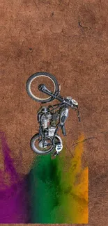 Vintage motorcycle with colorful abstract splash on a textured brown background.