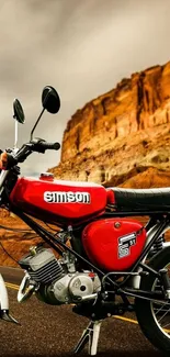 Vintage red motorcycle in canyon landscape wallpaper.