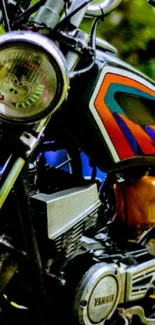 Close-up of a vintage motorcycle with vibrant colors on the tank.