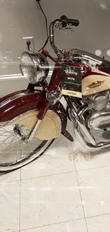 Vintage red and cream motorcycle on tiled floor.