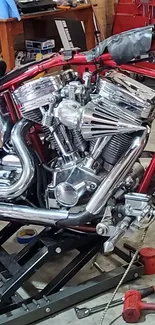 Close-up of shiny chrome motorcycle engine in a garage setting.