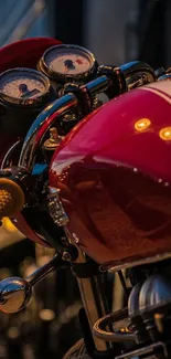 Vintage motorcycle with shiny gauges and red tank in evening light.