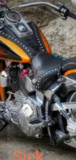 Vintage motorcycle with orange accents on rugged terrain background.