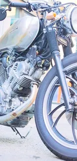 Vintage motorcycle with metallic finish parked outside.