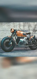 Vintage motorcycle with copper finish against a rustic wall background.