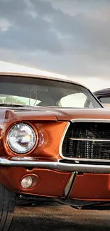 Vintage bronze Mustang car parked under cloudy sky