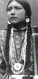 Vintage black and white portrait of a Native American individual with braided hair.