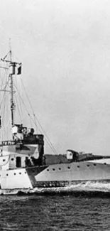 Black and white image of a vintage naval ship at sea.