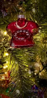 Red vintage phone ornament on a glowing Christmas tree.