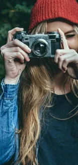 Girl with vintage camera in nature backdrop.