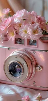 Vintage pink camera with flowers in bloom decoration.