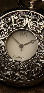 Vintage pocket watch with intricate metallic design.