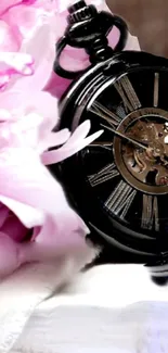 Vintage pocket watch with pink roses and elegant design.