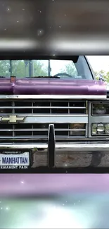 Front view of a purple vintage truck with license plate Manhattan.