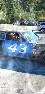 Vintage race car parked outdoors on a sunny day.