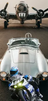 Vintage airplane, classic car, and motorcycle on runway.