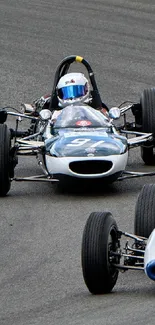 Vintage racing car on track, showcasing speed and classic design.