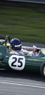 Vintage racing car speeding on track with green and yellow design.