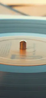 Close-up mobile wallpaper of a vintage record player with warm tones.