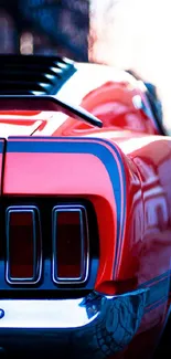 Vintage red muscle car rear on a city street at dusk.