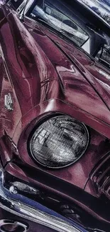 Classic maroon vintage car with chrome accents up close.