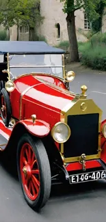 Vintage red car on a serene street.