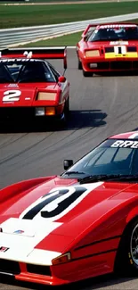 Vintage red race cars on a track, capturing speed and elegance.