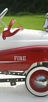 Vintage red toy fire truck pedal car mobile wallpaper.