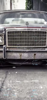 Close-up of vintage car in gray, showcasing classic retro design.