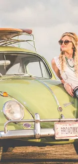 woman leaning on vintage green car with surfboards.