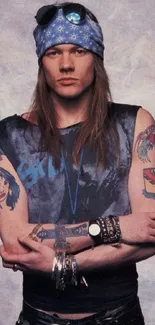 Vintage rockstar with tattoos and blue bandana in cool pose.