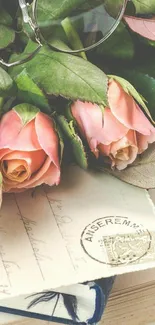 Vintage wallpaper with pink roses and antique postcards, accented by green leaves.