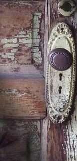 Close-up of a vintage rustic door with an antique knob and keyholes.