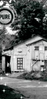 Black and white vintage cabin with trees, creates a rustic, artistic wallpaper.