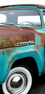 Vintage teal truck with rusted exterior in detailed close-up.