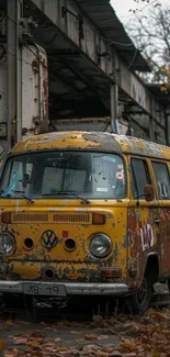 Rusty vintage van parked on autumn leaves.