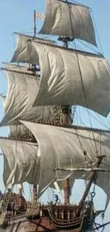 Classic sailing ship on serene ocean blue.