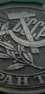 Close-up of Soviet emblem with metallic textures and historical symbols.