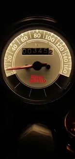 Mobile wallpaper of a vintage motorcycle speedometer with a black background.