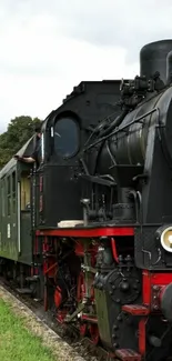 Mobile wallpaper with a vintage steam train in a scenic countryside setting.