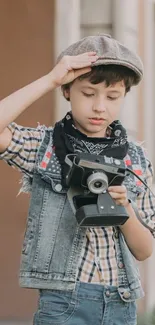 Young boy in vintage style capturing moments with a retro camera.