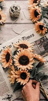 Vintage sunflower wallpaper with newspaper and rustic accents.