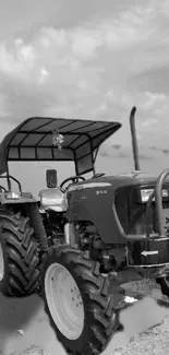 Black and white vintage tractor by a calm waterside.