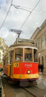 Vintage yellow tram on a Lisbon street with urban architecture backdrop.