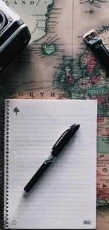 Vintage map wallpaper with camera, notebook, pen, and watch.