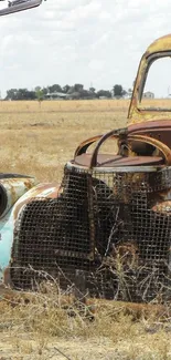 Rusted vintage truck in desert scenery with airplane overhead.