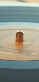 Close-up of a vintage vinyl turntable spinning softly in warm lighting.