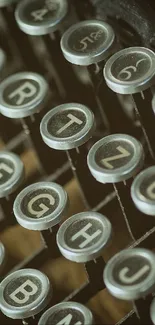 Close-up of vintage typewriter keys on a dark brown background.
