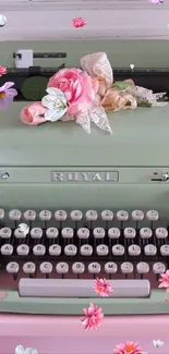 Vintage typewriter with flowers on pink background.