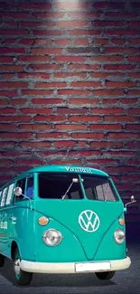 Blue vintage van in front of a brick backdrop.